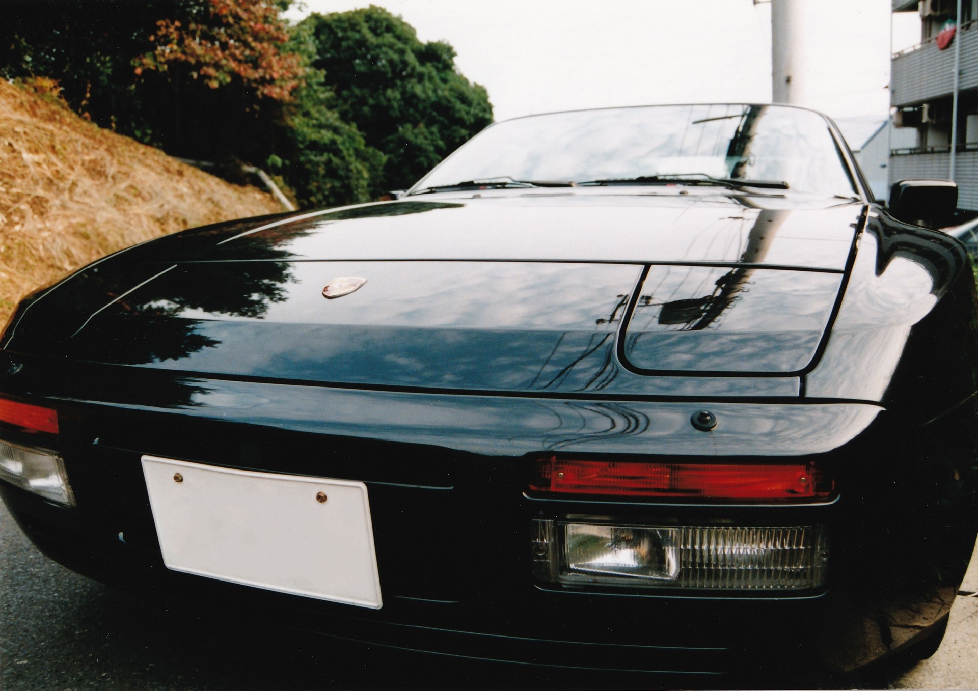 Schwarzer Porsche 944 Turbo S mit integrierter Frontschürze und Zusatzscheinwerfern, Frontansicht